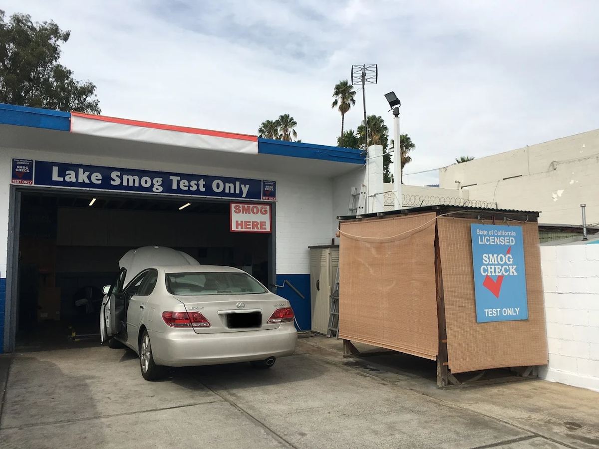 Car with its hood open in the test bay at Lake Smog Test Only in Pasadena during a smog check inspection